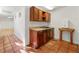Rustic basement kitchen features wood cabinets, tile floors, sink and small table at 1019 Henna Se Ct, Conyers, GA 30013