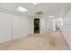 Finished basement with white walls, carpet flooring and access to utility room at 1019 Henna Se Ct, Conyers, GA 30013