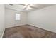 Bedroom with neutral carpet, ceiling fan, and a door leading outside at 1019 Henna Se Ct, Conyers, GA 30013
