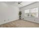 Neutral carpeted bedroom with a ceiling fan, crown molding, and windows with blinds at 1019 Henna Se Ct, Conyers, GA 30013
