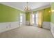 Elegant dining room featuring decorative trim, neutral carpet, and ample natural light for a warm atmosphere at 1019 Henna Se Ct, Conyers, GA 30013