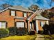 Charming brick home featuring a manicured lawn, black window shutters, and a welcoming entrance at 1019 Henna Se Ct, Conyers, GA 30013