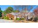 Charming two-story brick home featuring manicured landscaping and a well-maintained lawn on a sunny day at 1019 Henna Se Ct, Conyers, GA 30013