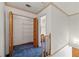 Hallway features closet with folding doors, blue carpet, and access to bathroom at 1019 Henna Se Ct, Conyers, GA 30013