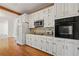 Bright kitchen with white cabinets, granite counters, and stainless appliances at 1019 Henna Se Ct, Conyers, GA 30013
