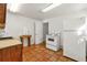 Cozy kitchenette area featuring tile flooring, vintage range, and white refrigerator at 1019 Henna Se Ct, Conyers, GA 30013