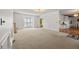 Spacious living room with large windows allowing ample natural light, showcasing the open layout at 1019 Henna Se Ct, Conyers, GA 30013