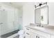 Bathroom featuring a glass-enclosed shower, modern fixtures, and patterned floor tiles at 1211 Reeder Ne Cir, Atlanta, GA 30306