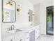 Elegant bathroom featuring double sinks, sleek countertops, modern fixtures, and a glass-enclosed shower at 1211 Reeder Ne Cir, Atlanta, GA 30306