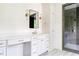 Stylish bathroom showcasing a vanity with ample storage, contemporary lighting, and a luxurious glass-enclosed shower at 1211 Reeder Ne Cir, Atlanta, GA 30306