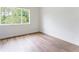 Bright and airy bedroom with hardwood floors, a large window, and ample natural light, creating a welcoming atmosphere at 1211 Reeder Ne Cir, Atlanta, GA 30306
