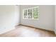 Inviting bedroom space with hardwood floors, a spacious window offering scenic views, and abundant natural light at 1211 Reeder Ne Cir, Atlanta, GA 30306