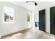 Spacious bedroom with two windows, hardwood floors, and contemporary black doors at 1211 Reeder Ne Cir, Atlanta, GA 30306
