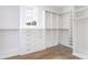 Bright, walk-in closet features white custom shelving and hardwood floors at 1211 Reeder Ne Cir, Atlanta, GA 30306