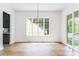 Spacious dining room with hardwood floors features a view of the outdoor balcony and connects to the kitchen at 1211 Reeder Ne Cir, Atlanta, GA 30306