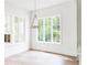 Sunlit dining area with large windows and hardwood floors provides an airy and inviting space at 1211 Reeder Ne Cir, Atlanta, GA 30306