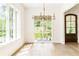 Bright dining room with hardwood floors features a modern chandelier and view of the outdoor balcony at 1211 Reeder Ne Cir, Atlanta, GA 30306