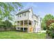 Expansive backyard view of a two-story home with outdoor space and lush lawn, showcasing modern architecture at 1211 Reeder Ne Cir, Atlanta, GA 30306