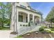 Three quarter view of an exterior elevation with covered front porch with stairs at 1211 Reeder Ne Cir, Atlanta, GA 30306