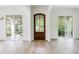 Entryway with hardwood floors and a wooden front door flanked by windows overlooking the porch at 1211 Reeder Ne Cir, Atlanta, GA 30306
