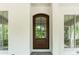 Close-up of a wooden front door, flanked by windows and white painted brick at 1211 Reeder Ne Cir, Atlanta, GA 30306