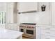 New kitchen showcasing stainless steel appliances, custom cabinets, and modern backsplash at 1211 Reeder Ne Cir, Atlanta, GA 30306