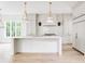 Bright, open kitchen with large island, pendant lights, stainless appliances and custom white cabinets at 1211 Reeder Ne Cir, Atlanta, GA 30306