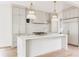 Gourmet kitchen with large island, pendant lighting, white cabinets, and stainless steel appliances at 1211 Reeder Ne Cir, Atlanta, GA 30306