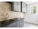 Well-appointed laundry room with custom cabinets, granite countertops, and stylish fixtures at 1211 Reeder Ne Cir, Atlanta, GA 30306