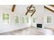 Living room features exposed beams, fireplace, hardwood floors and lots of windows at 1211 Reeder Ne Cir, Atlanta, GA 30306