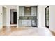 Open living room featuring wood floors, a wet bar with beverage fridge, and plenty of light at 1211 Reeder Ne Cir, Atlanta, GA 30306