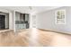 Bright living room featuring hardwood floors and a stylish wet bar with beverage fridge at 1211 Reeder Ne Cir, Atlanta, GA 30306