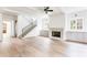 Living room showcasing an open floorplan, fireplace, stairway, and hardwood floors at 1211 Reeder Ne Cir, Atlanta, GA 30306
