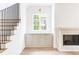 Living room with a fireplace, window, and storage cabinets that create a cozy yet organized ambiance at 1211 Reeder Ne Cir, Atlanta, GA 30306