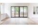 Open living room with a sliding glass doors leading to an outdoor deck, and built-in cabinets at 1211 Reeder Ne Cir, Atlanta, GA 30306