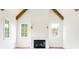 Living room featuring exposed beams, fireplace, hardwood floors and lots of windows at 1211 Reeder Ne Cir, Atlanta, GA 30306