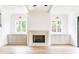 Bright living room featuring a stone fireplace, built-in cabinets and large windows offering natural light at 1211 Reeder Ne Cir, Atlanta, GA 30306