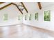Living room features exposed beams, fireplace, hardwood floors and lots of windows at 1211 Reeder Ne Cir, Atlanta, GA 30306