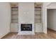 Bright living room with a fireplace, built-in shelving, and hardwood floors at 1211 Reeder Ne Cir, Atlanta, GA 30306