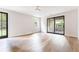 Open living room featuring wood floors, white walls and lots of light from windows and doors at 1211 Reeder Ne Cir, Atlanta, GA 30306