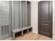 Gray mudroom with storage and bench by an exterior door at 1211 Reeder Ne Cir, Atlanta, GA 30306