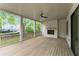 Covered porch featuring a ceiling fan, white brick fireplace and exterior access at 1211 Reeder Ne Cir, Atlanta, GA 30306