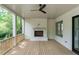 Inviting covered porch with a brick fireplace and a ceiling fan at 1211 Reeder Ne Cir, Atlanta, GA 30306