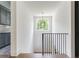Staircase with a window and modern chandelier, and featuring black iron railing and hardwood floors at 1211 Reeder Ne Cir, Atlanta, GA 30306