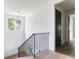 Bright staircase features black iron railing, hardwood floors and a modern pendant light at 1211 Reeder Ne Cir, Atlanta, GA 30306