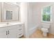 Clean bathroom featuring a large mirror, modern vanity, and a shower-tub combination at 3134 Hudson Pond Ln, Marietta, GA 30062
