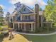 Stately two-story brick home with a covered front porch and mature landscaping at 3134 Hudson Pond Ln, Marietta, GA 30062
