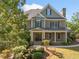 Charming two-story home with a covered front porch surrounded by lush greenery at 3134 Hudson Pond Ln, Marietta, GA 30062