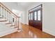 Bright foyer with hardwood floors, a staircase, and a decorative front door at 3134 Hudson Pond Ln, Marietta, GA 30062