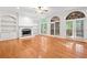 Spacious living room with hardwood floors, fireplace, and large windows for natural light at 3134 Hudson Pond Ln, Marietta, GA 30062